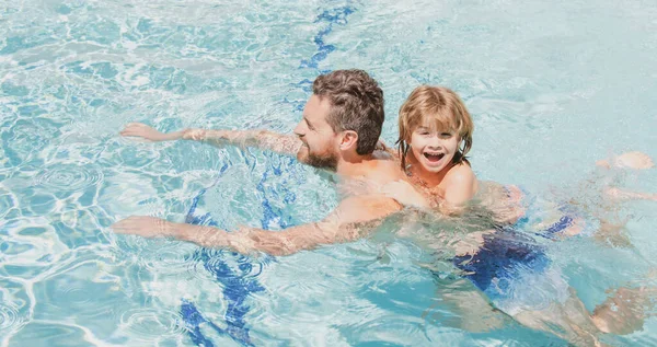 Father and son swimming in pool, summer family. Swimming lessons. Summer vacation. Father and son leisure. Fathers Day.