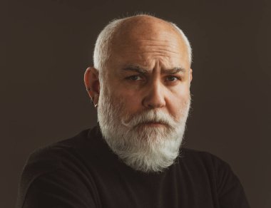 Siyah arka planda olgun bir adamın portresi.