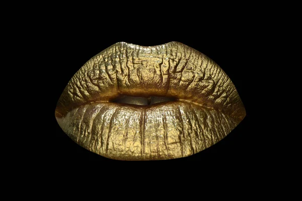 Luxury gold lips make-up. Golden lips with golden lipstick. Gold paint on lips of sexy girl. Sensual woman mouth, isolated background. Glamour lips concept