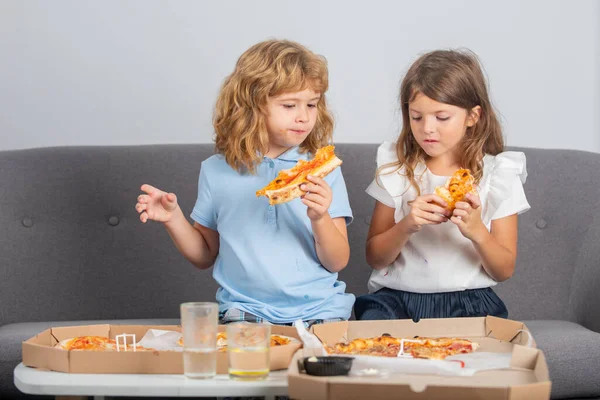 Happy daughter and son eating pizza. Children kids, little girl and boy eat pizza. — Stock Photo, Image