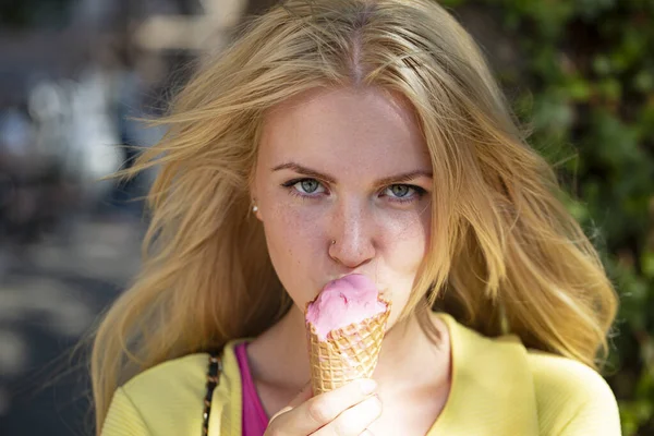 年轻女子在户外吃冰淇淋的肖像。漂亮脸庞的浪漫女孩. — 图库照片