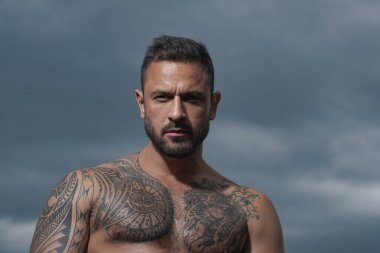 Ciddi yüzlü yakışıklı bir adamın portresi. Çıplak ve güçlü gövde..