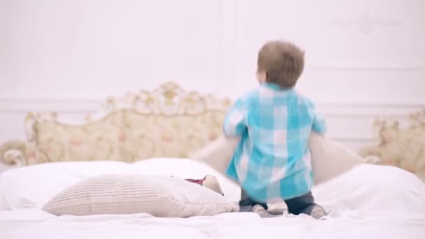 재밌는 애들 이 침대에서 뛰어내렸어. 아들 이 침대에서 베개를 들고 노는 모습. — 비디오