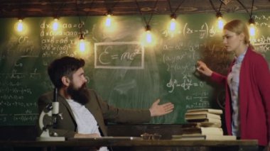 Matematik okulunda matematik dersi öğretmeni. Üniversitede tahtada düşünen bir kız öğrenci. Birkaç öğretmen. Bir sınıfta ders veren bir profesör, eğitim konsepti. Matematik dersi.