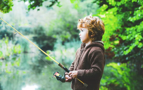 Retrato de niño lindo pesca niño. Niño con carrete giratorio. —  Fotos de Stock