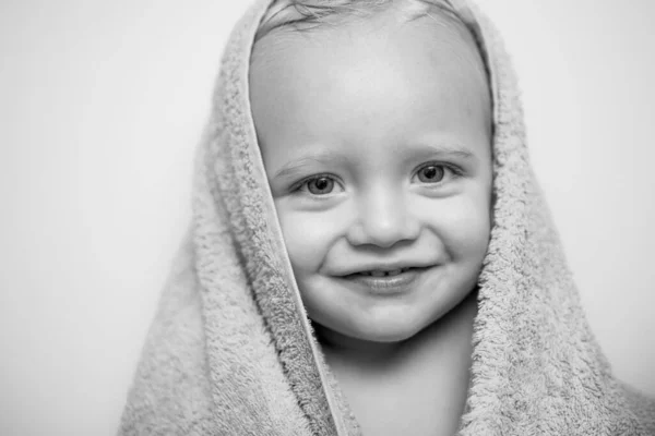 Kleine baby lacht onder een witte handdoek. Glimlachend jongetje zwemmen onder een douche thuis. Happy Bad tijd. — Stockfoto