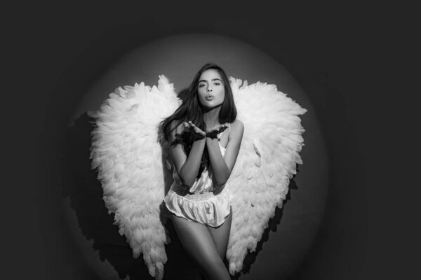 Valentines Day concept. Cupid woman. Valentines Day symbol. Angel woman with feather white wings and gift