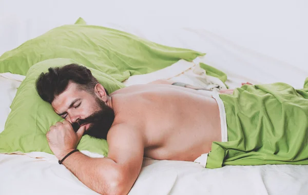 Bored sleepless and tired in bed. Man sleep in bed alone. Happy to Sleep. Sleep disorders concept. Guy lying in bed try to relax and fall sleep. — Stock Photo, Image