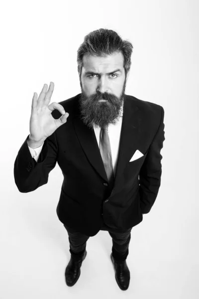 Businessman in suit. Business man in black suit smiling and showing ok sign studio isolated on white background. Wide angle, top view. — Stock Photo, Image