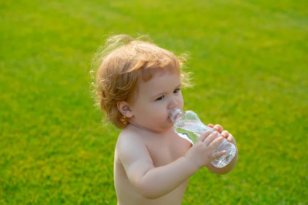 아이들은 물을 마십니다. 아이들 이 바깥에 있는 병에 든 생수를 마신다. — 스톡 사진