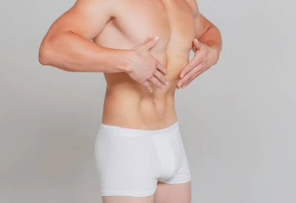 Een slanke maag. Fitness en gezonde levensstijl. Mannetjes ondergoed. — Stockfoto