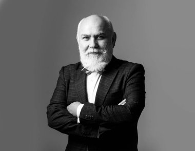 Kollarını kavuşturmuş kıdemli adam. Yaşlı, yaşlı, olgun bir adam..