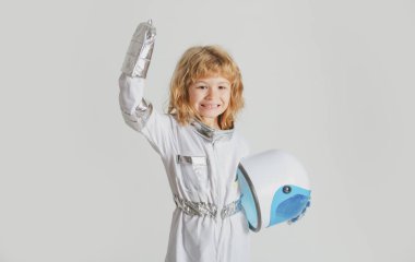 Uzay kaskı ve metal kıyafetiyle astronot olmaya çalışan harika bir çocuk..