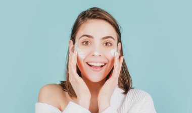 Cilt için nem. Güzel bir kadın yüzüne temizleyici bir maske takar. Kadın cilt bakımı, yüz güzelliği portresi..