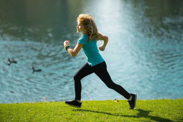 Child boy jogging in park outdoor. Sporty kid running in nature. Active healthy child boy runner jogging outdoor. — Stock Photo, Image