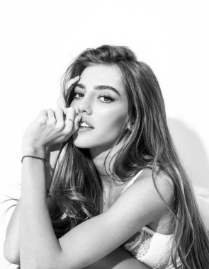 Yatakta battaniyeli ve kameraya bakan neşeli genç bir kadın. Şehvetli kız yatakta uyuduktan sonra kendini zinde hissediyor. Gülen kadın yastık ve battaniyeyi kucaklarken eğleniyor..