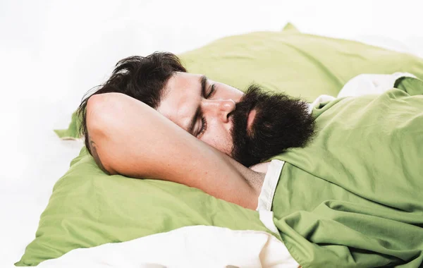 Violations of sleep and wakefulness. Young man sleeping on soft pillows in bed at home. Man bearded hipster having problems with sleep. — Stock Photo, Image