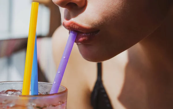 Closeup of womans lips drinking with pink straw. Woman drink cocktail. Close up wet sexy lips. — Stock Photo, Image