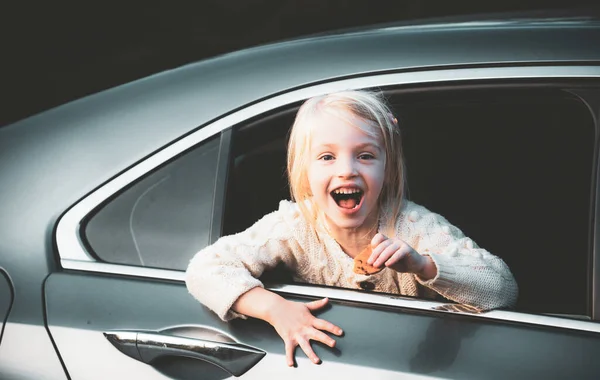 Excited little girl admiring looks of the car on the street. Cute little child girl smiling and having fun to travel by car. — Stock Photo, Image