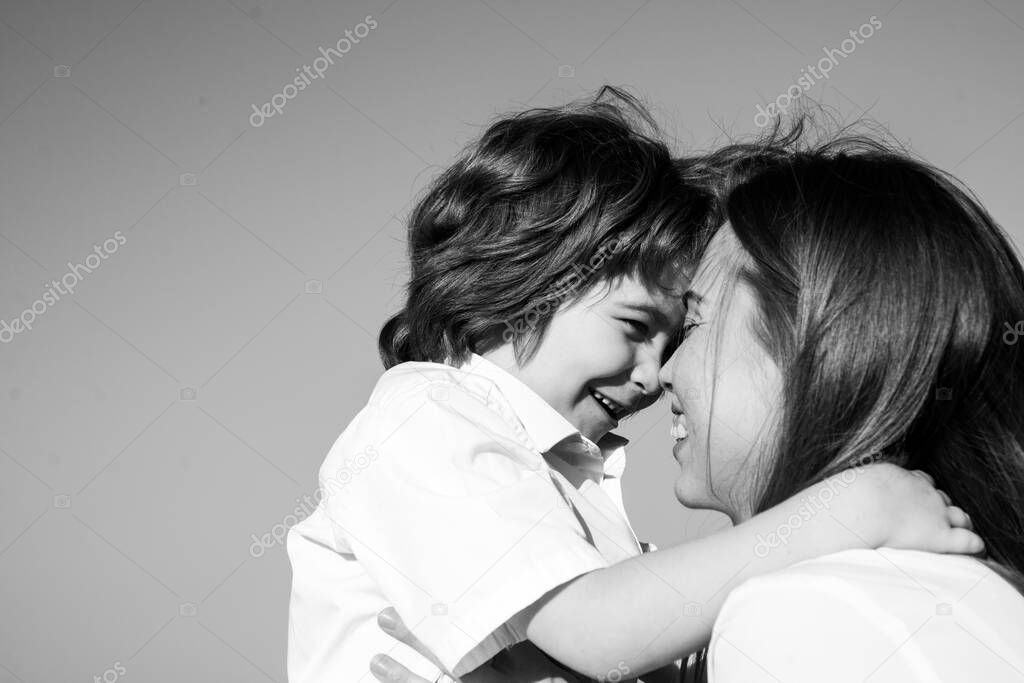 Motherhood. Child son hug mom. Mother and boy smiling and hugging. Family holiday and togetherness.