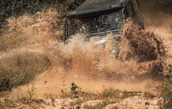 Il fuoristrada va in montagna. Veicolo fuoristrada che esce da un buco di fango pericoloso. Spedizione offroader. Un SUV Safari. Trekking di viaggio 4x4. Avventura stradale. Viaggio avventura . — Foto Stock