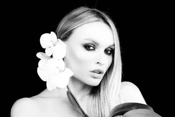 Cura della bellezza. Prodotti cosmetici. Donna con fiore di orchidea. — Foto Stock