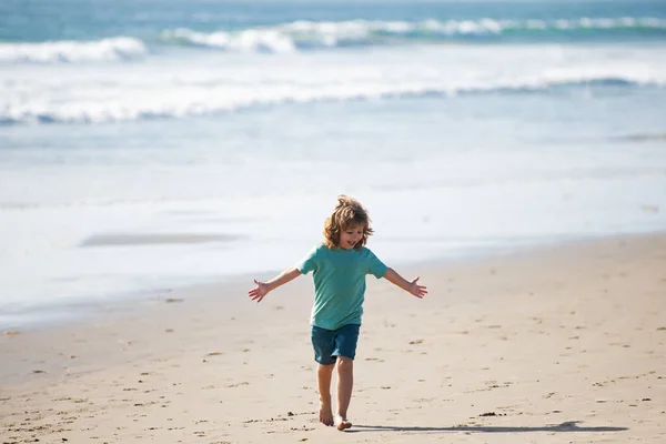 Niño caminar a la playa del mar, las manos levantadas. Sorprendido niños sorprendidos emociones. — Foto de Stock