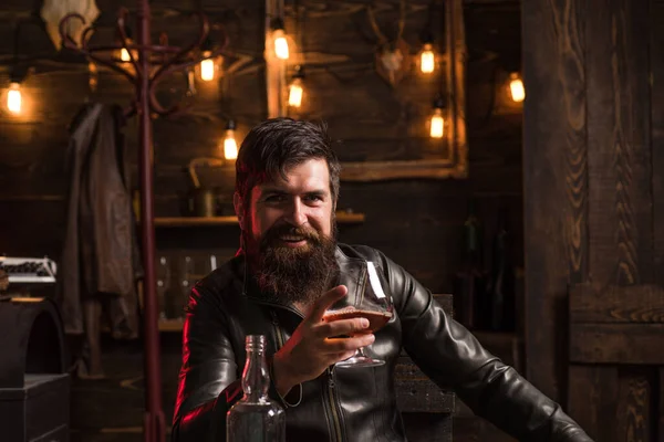 Man with beard holds glass brandy. Bearded drink cognac. Expensive drink. Man in shirt drinking brandy or cognac. Sexy young man with glass of whiskey. — Stock Photo, Image