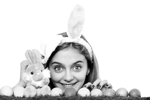 Caza de huevos. Chica en conejo de Pascua orejas de conejo con huevos. Mujer mirando por encima de una superficie. — Foto de Stock