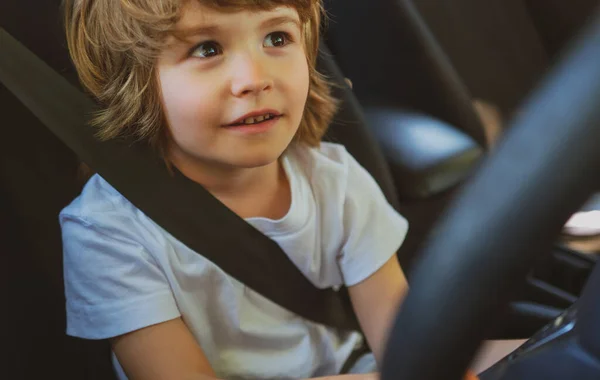 Child driver. Cute child boy while driving car as driver. Baby kid sitting in seat. — Stock Photo, Image