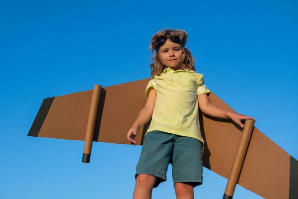 空におもちゃのジェットパックで遊ぶ子供。子供のパイロット宇宙飛行士や宇宙飛行士の夢。ボールボードの翼を持つ飛行士の少年. — ストック写真