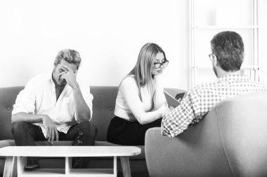 Aile içi sorunları sosyal hizmetler görevlisi ya da aile psikologu ile tartışan bir çift. Depresyon terapisi, aile terapisi..