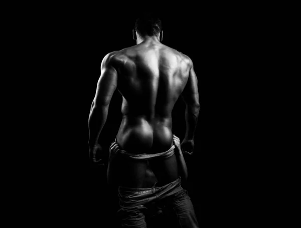 Bare torso. A man in underpants on black background isolated. Mens ass in underwear. Naked male ass. Oral sex. Woman with the tongue of the male buttocks. — ストック写真