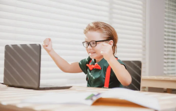 ラップトップを使ってオンラインで勉強する小学生の子供。コンピュータを使ってオンラインスクールに通う子供. — ストック写真