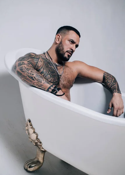 Seductive sexy man in bath. Macho looking confident.