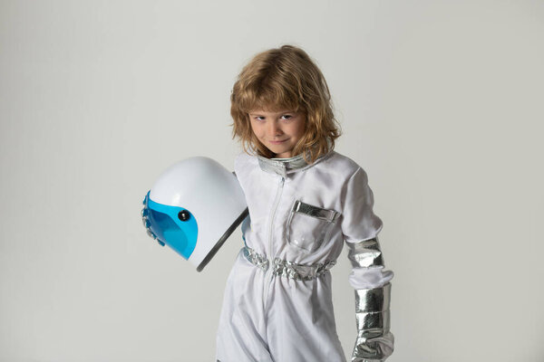 Small child wants to fly an in space wearing an astronaut helmet. Copy space. Kids innovation and inspiration.