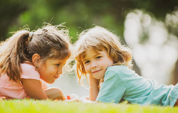 Cute couple of kids in love. Children relationships. Little boy girl outdoors in park.