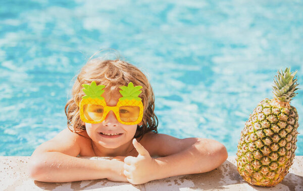 Kid enjoying summer in swimming pool. Children playing and active leisure. Summer kids vacation. Funny amazed face.