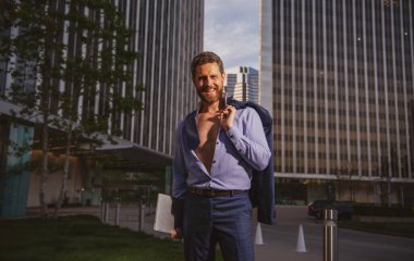 Takım elbiseli beyaz iş adamı ofisten çıkıyor. Son çalışma günü konsepti. Seksi moda işadamı.