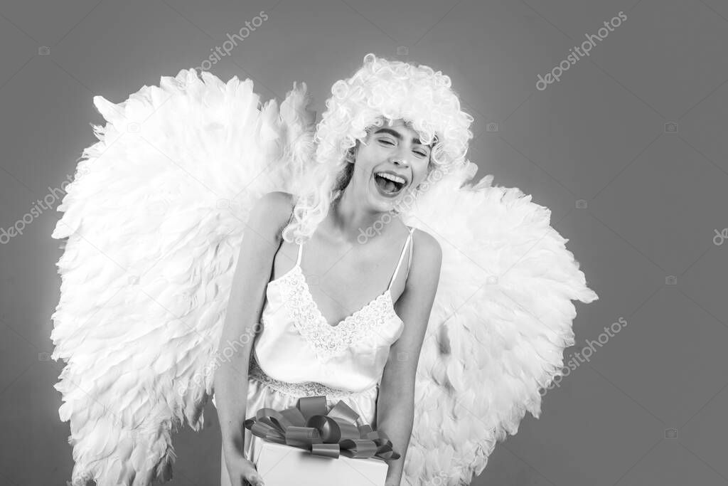 Funny blonde angel girl with white wings. Fallen white angel.