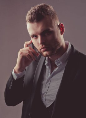 İşadamı telefon mobil ile çalışıyor. Lüks klasik takım elbiseler, moda. Erkek takım elbisesi modası. Toplantı telefonu.