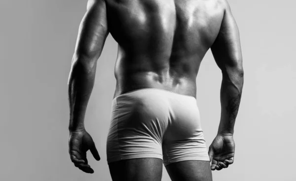 Man buttocks in yellow underpants. Muscular man with muscular buttocks. Bare nude torso, Naked male ass. — 图库照片