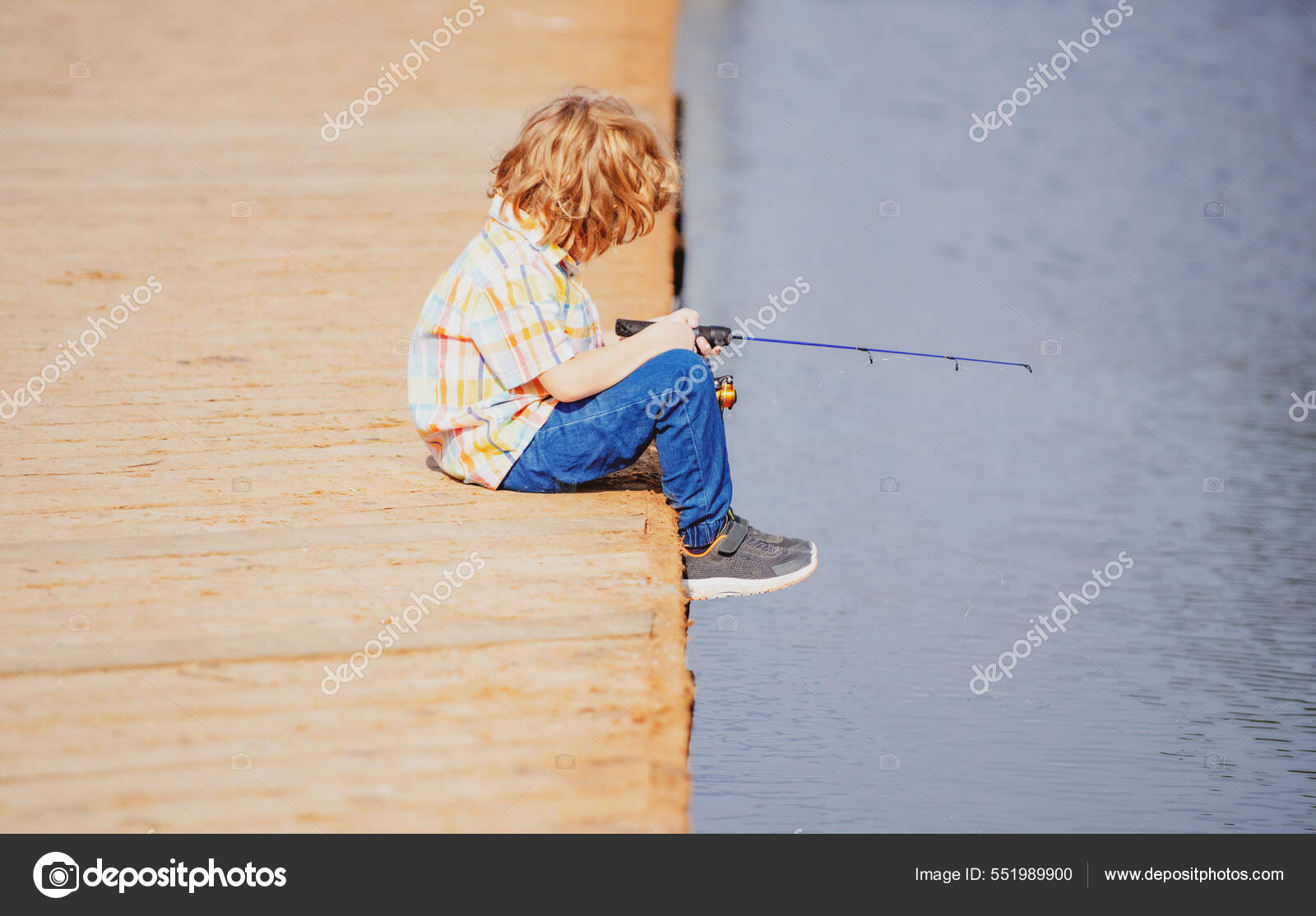 Fishing concept. Child fishing on the lake. Young fisher. Boy with spinner  at river. Portrait of excited boy fishing. Boy at jetty with rod. Stock  Photo by ©Tverdohlib.com 551989900