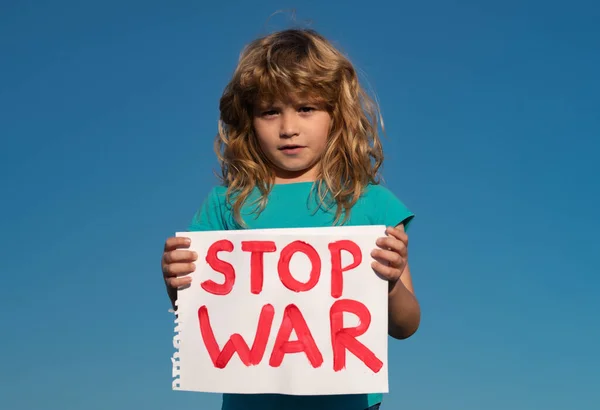 Help now and Ukrainian flag. Protest against war in Ukraine. Child holding sign with words Stop war standing outdoors. — Stock Photo, Image