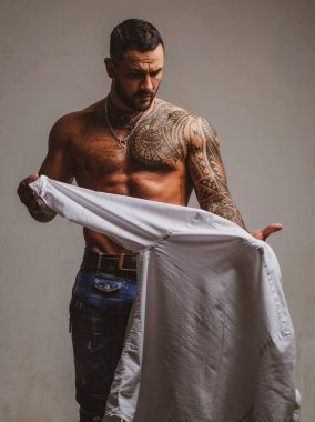 Sexy man undressing shirt. Sexual desire. Sensual guy. clipart