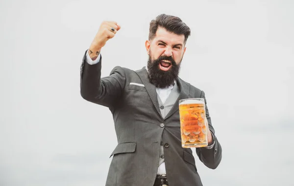 Funny man in classical suit holding glass with beer in hand. Excited man with beer. Bartender brewer with expression emotions. — Stock Photo, Image