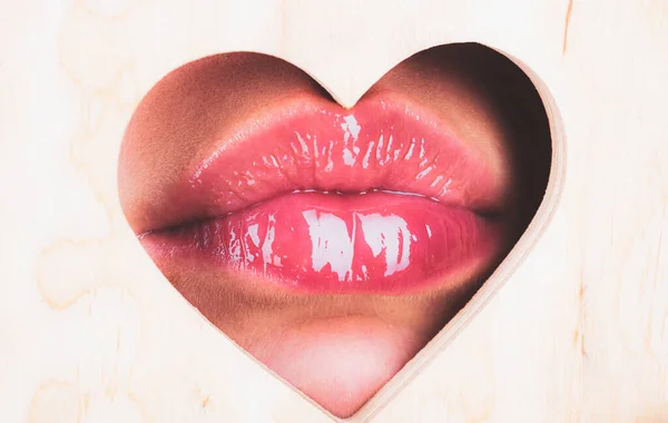 Heart shape. Girl Natural beauty lips. Red lip with glossy lipgloss. Close up, macro with beautiful mouths. Sexy kiss, sensual seductive lips of a young woman. Cosmetics and beauty salon. — Stock Photo, Image