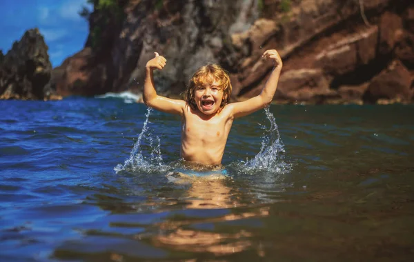 Incroyable enfant excité im eau de mer. Enfant drôle jouant sur la plage. — Photo