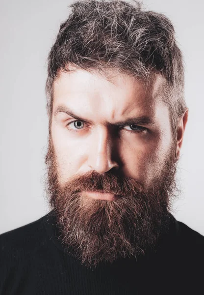 Close-up image of serious brutal bearded man on white background. Confident and dramatic concept. — Stock Photo, Image