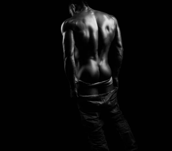Panties down. Young mens naked ass and back on black isolated background. Metrosexual concept. Shirtless undressed sexy man turned back. Masculine buttocks. — Stock fotografie